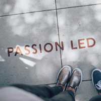 Some feet on concrete, text reads "Passion Led"